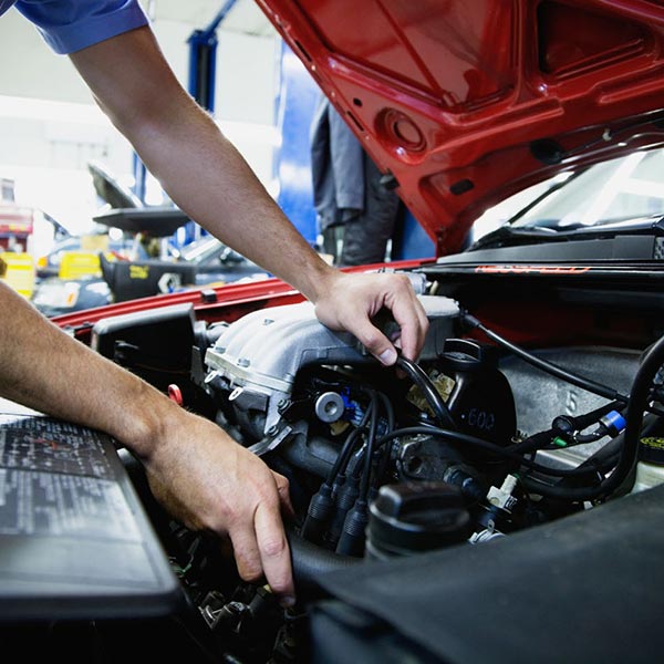 mechanic in car engine bay